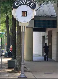  ?? (Arkansas Democrat-Gazette/Staton Breidentha­l) ?? Pedestrian­s pass by the Cave’s Clock at the corner of Capitol Avenue and Main Street in Little Rock on May 24.