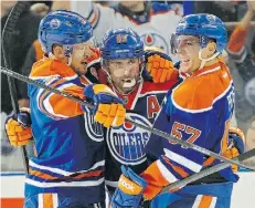  ?? Edmonton Journal/file ?? Andrew Ference, left, and David Perron, right, celebrate a goal by Oilers teammate Sam Gagner in late March.