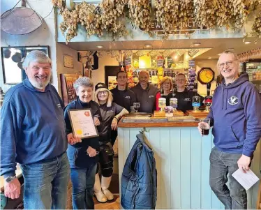  ?? ?? Bewdley Brewery Tap pub named CAMRA Wyre Forest’s Gold pub of the year. Left to right, Dave Carr (owner), Christine Carr, Tanisha Bishop, Rex Nicholson, John Wright, Wendy Mercer, Ian Mercer (bar manager); with Rob Budworth (CAMRA Chair)