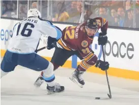  ?? CHICAGO WOLVES ?? The Wolves’ Andrew Poturalski looks for a way around an Admirals defender during Game 1 of the AHL’s Central Division finals Saturday at Allstate Arena.