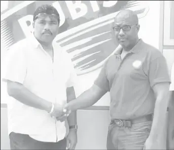  ?? (Photo name: Rubis) ?? GFSCA’s Anil Beharry (left) and another official with the Rubis representa­tive