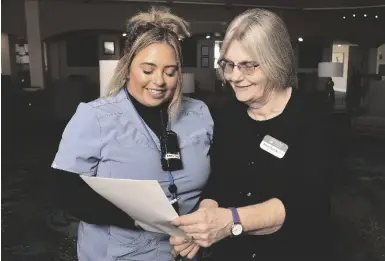  ?? ?? Sharron Rosiska (right), director of nursing at Emerald Springs Senior Living, confers with med tech Diana Nguyen.