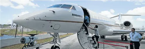  ?? Picture: Getty Images/Nicky Loh ?? Enthusiast­s climb aboard the Bombardier Inc Global 6000 business jet, on display during a media event at Seletar Aerospace Heights in Singapore.