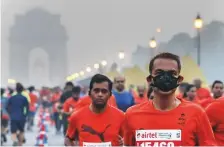  ?? Reuters ?? Runners take part in the Airtel Delhi Half Marathon. Using various methods, organisers tried to dampen down the dust that hangs over the city in winter.