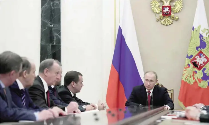  ??  ?? MOSCOW: Russian President Vladimir Putin, right, chairs a Security Council meeting in the Kremlin. — AP