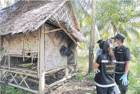  ??  ?? HITTING CLOSE TO HOME: Police inspect a shack in Ban Koh Raet of Phangnga’s Takua Thung district on Wednesday where a teenage girl said she was sexually abused.