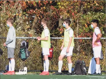  ??  ?? Players on the sidelines were required to wear masks during the boys soccer game between New Milford and Abbott Tech high school Thursday afternoon at Broadview Middle School in Danbury.