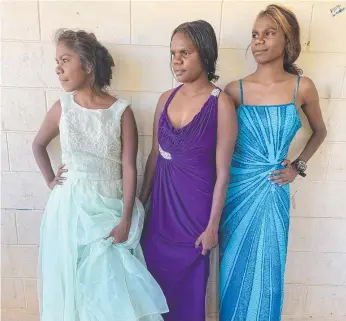  ??  ?? Doomadgee women Shyeisha Lorraine, 20, Leeara Chong, 15, and Tennisha Walden, 18, try on dresses donated for the NAIDOC ball in July. Picture: Yolonde Entsch