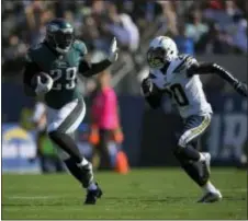  ?? MARK J. TERRILL — THE ASSOCIATED PRESS ?? Running back LeGarrette Blount (29) gallops upfield as Chargers defensive back Desmond King (20) gives chase during the second half Sunday. Smallwood and the other Eagles’ running backs ran wild thanks to strong protection by the offensive line.