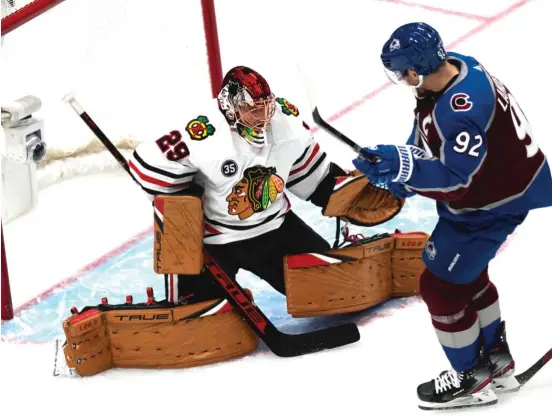  ?? DAVID ZALUBOWSKI/AP ?? Blackhawks goaltender Marc-Andre Fleury stops a shot off the stick of Avalanche left wing Gabriel Landeskog in the first period Wednesday.