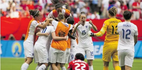  ?? Ben Nelms/Getty Images ?? Casey Stoney, centre, celebrates with her English teammates after defeating Canada 2-1 in the quarter-finals Saturday.