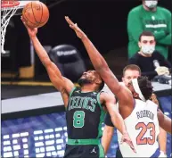  ?? Adam Glanzman / Getty Images ?? The Celtics’ Kemba Walker (8) is fouled by the Knicks’ Mitchell Robinson as he scores during Sunday’s game.