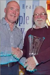  ??  ?? Internatio­nal Person of the Year Theo Phelan receives his award from Joe Healy.