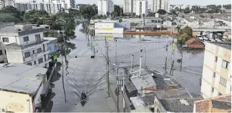  ?? CARLOS MACEDO, THE ASSOCIATED PRESS ?? A boat navigates along a flooded street after heavy rain in Canoas, Rio Grande do Sul state, Brazil, on Wednesday.