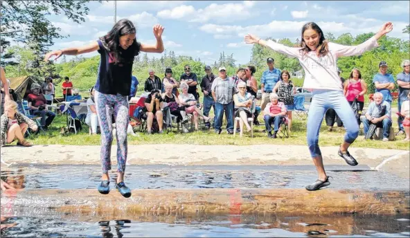  ?? KATHY JOHNSON ?? Twins Valeria (left) and Karla Thibeault have fun logrolling during the junior edition of the Beaver Dam Sports Meet at the Wild Axe Park.