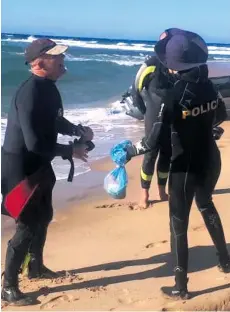  ??  ?? Police divers prepare to search for the bodies of Prophet Thobani Zwane and Fezile Ndlovu