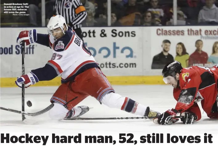  ?? Photo / Getty Images ?? Donald Brashear (left) in action at age 52. The former NHL enforcer still loves the game.