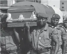  ?? STRINGER/AFP/GETTY IMAGES ?? Soldiers carry the coffin of one of four soldiers killed in violence in the English-speaking area of Bamenda.