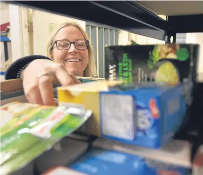  ?? Picture: Kris Miller. ?? Project coordinato­r Eleanor Kelleher sorts out the donated items.