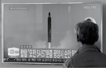  ??  ?? SOUTH KOREA. A man watches a TV screen showing file footage of North Korea's missile launch, at the Seoul Railway Station in Seoul, South Korea, Tuesday, August 29. The signs read " South Korea's Joint Chiefs of Staff said North Korea fired a ballistic...