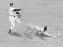  ?? PETER J. CARROLL, THE ASSOCIATED PRESS FILE PHOTO ?? Boston Red Sox Hall of Famer Bobby Doerr, who often led AL second basemen in double plays, put-outs and assists, turns a double-play on the Tigers’ Steve Souchock May 20, 1951.