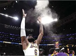  ?? MARK J. TERRILL / AP ?? Los Angeles Lakers forward LeBron James tosses powder in the air prior to Game 3 of a first-round NBA playoff series against the Memphis Grizzlies on Saturday.