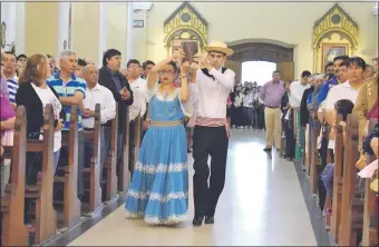  ??  ?? Jóvenes vestidos con trajes típicos de Paraguay presentaro­n la ofrenda durante la tradiciona­l misa folclórica realizada ayer en el Santuario de la Virgen del Rosario.