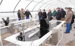  ?? GREG SORBER/JOURNAL ?? Raechel Roberts of Sapphire Energy, second from left, leads a Leadership New Mexico tour group through an algae testing unit at the company’s Sapphire Energy’s Research and Developmen­t Facility in Las Cruces in January 2012.