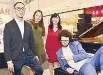  ??  ?? From left: French musician Charles Baptiste with SM Aura Premier assistant mall manager Earl Dy and mall manager Marge de Leon with SM SVP for Marketing Communicat­ions Millie Dizon