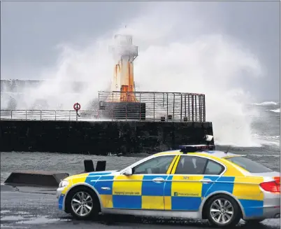  ??  ?? ARDROSSAN: Police sit at Ardrossan Harbour as Storm Barbara wreaks havoc ahead of Storm Conor’s arrival tomorrow. Picture: Jeff J Mitchell