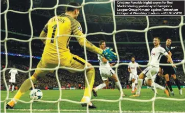  ??  ?? Cristiano Ronaldo (right) scores for Real Madrid during yesterday’s Champions League Group H match against Tottenham Hotspur at Wembley Stadium. – REUTERSPIX
