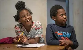  ?? Alexandra Wimley/Post-Gazette ?? Zariyah Johnson, 7, does homework alongside her brother Zyon, 5, Thursday at their home in Observator­y Hill. Their mom, Bridgette Johnson, is a single mother.