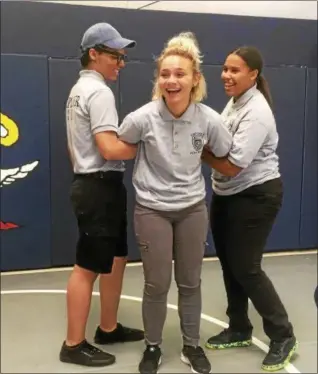  ?? ZACH SRNIS — THE MORNING JOURNAL ?? Meriah Harris, 17, a senior at Lorain High School, is in the middle of an escort hold performed by Arianna Rivera, right, 16, a junior at Lorain High, and Axel Irizarry, 16, a Lorain High senior.