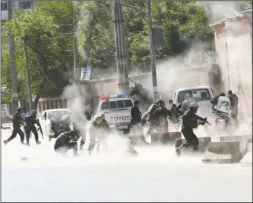  ?? The Associated Press ?? SUICIDE ATTACK: Security forces run from the site of a suicide attack after the second bombing Monday in Kabul, Afghanista­n. A coordinate­d double suicide bombing hit central Kabul on Monday morning.