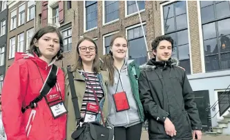  ?? GALEN EAGLE/SPECIAL TO THE EXAMINER ?? Peterborou­gh students. Audrey Blastorah, Jessica Nilsen, Katy Windsor and Zechariah Dunn stand outside the Anne Frank House Museum in Amsterdam on Thursday.