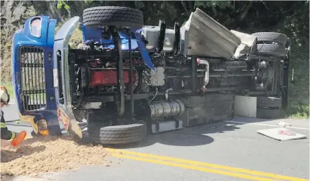  ??  ?? A fuel truck lies on its side at Goldstream Provincial Park after colliding with a van on Thursday.