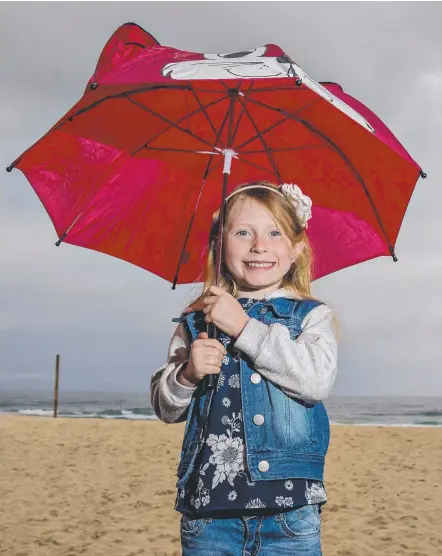  ?? Picture: JERAD WILLIAMS ?? Silver lining: The weekend’s wet weather meant Ella Blow could finally use her new umbrella.