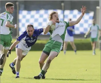  ??  ?? Ian Sheerin feels the force of this challenge from Paudge McWalter of St Pat’s.