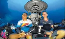  ?? PHOTO BY NEKTON VIA AP ?? Seychelles President Danny Faure, left, smiles after speaking from inside a submersibl­e from the vessel Ocean Zephyr, under the water off the coast of Desroches, in the outer islands of Seychelles on Sunday.