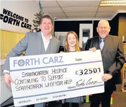  ??  ?? Vital cash Colin Dennis and Ian McWatt, Forth Carz, present a cheque for the cash to the hospice’s Clare McDonald