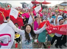  ?? NG HAN GUAN/ THE ASSOCIATED PRESS ?? Residents at the ski resort region of Chongli, China celebrate the news that Beijing has been selected by the IOC to host the 2022 Winter Olympics. The Chongli region will host Nordic skiing, ski jumping and other outdoor events for the Games.