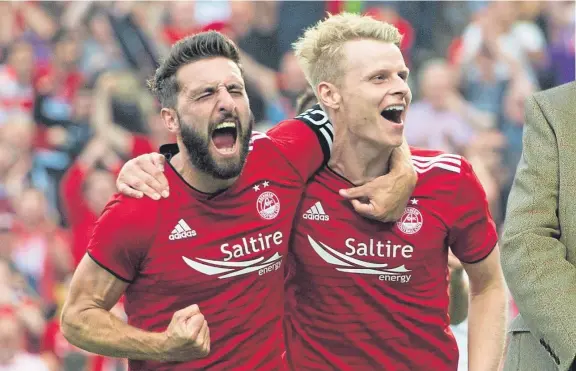  ?? Picture: SNS. ?? Graeme Shinnie and Gary Mackay-Steven celebrate the latter’s goal against Burnley at Pittdrie.