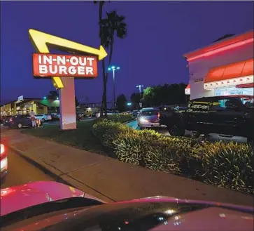  ?? Frederic J. Brown AFP/Getty Images ?? THE DRIVE-THROUGH has long been an American institutio­n. Above, an In-N-Out in Alhambra last year.