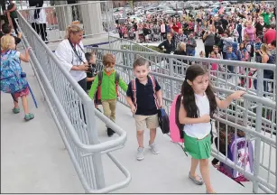  ?? File photo by Ernest A. Brown/The Call ?? Parents wave goodbye as students enter Potter-Burns Elementary School in Pawtucket on the first day of school last August.