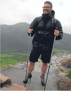  ??  ?? Ben Conway wearing his stilettos during his Ben Nevis climb.