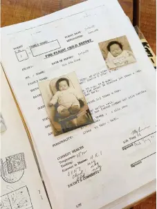  ?? File are seen on a table in ?? Baby pictures and a page of Koed’s adoption Copenhagen, Denmark.