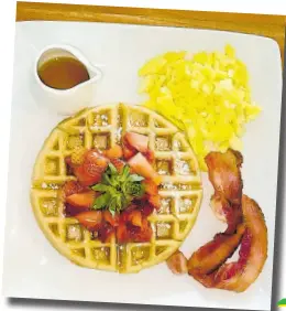  ?? ?? Relax and unwind with this waffle pancake, scrambled eggs and bacon.