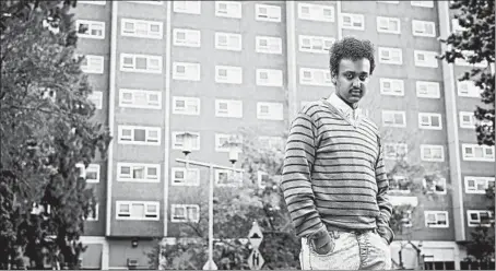  ?? CHRISTINA SIMONS/THE NEW YORK TIMES ?? Barry Berih, the son of Eritrean immigrants, stands in September outside the public housing tower where he lives in Melbourne, Australia.