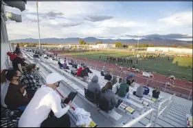  ??  ?? Fans watch a high school junior varsity football game March 19 between Moapa Valley and Pahrump Valley. Currently, only parents or legal guardians are allowed to attend the games in Pahrump; no fans are allowed at the spring games in Clark County.