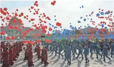  ?? IGOR SASIN, AFP/GETTY IMAGES ?? Parade participan­ts release balloons as they march in Turkmenist­an’s capital city of Ashgabat on Thursday, the 25th anniversar­y of the country’s independen­ce.